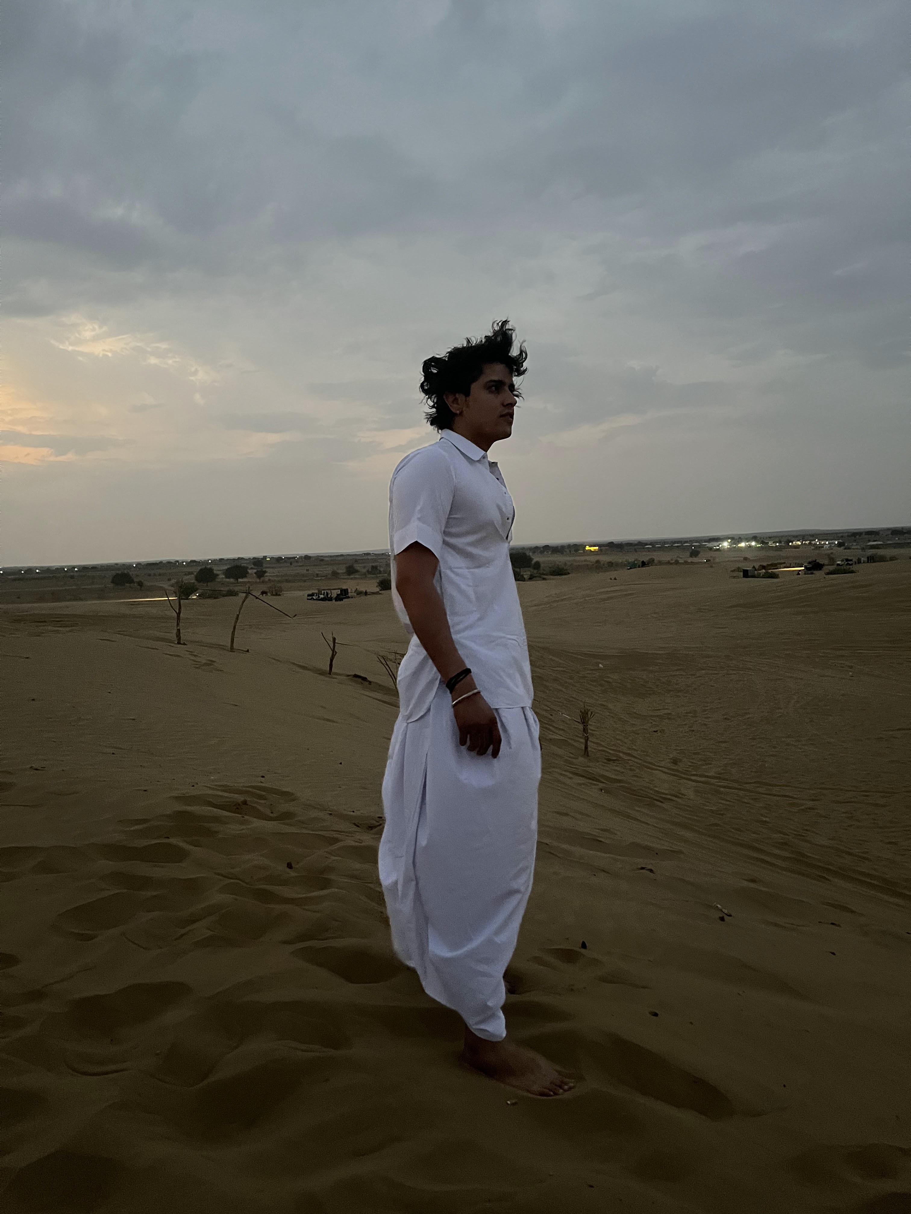 Gaurav standing in the desert at dusk